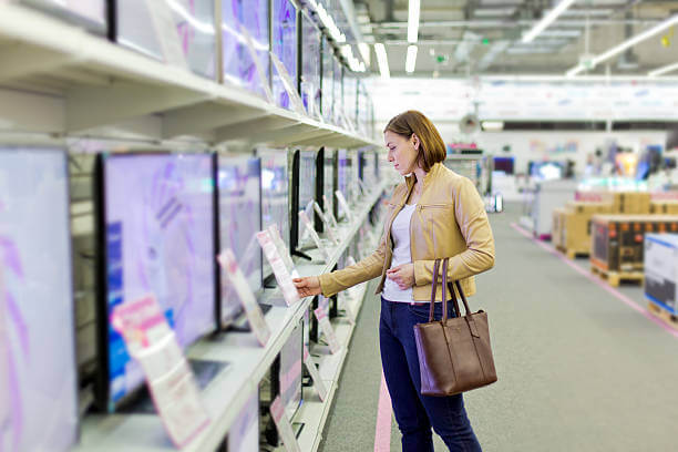 woman browsing tv in store